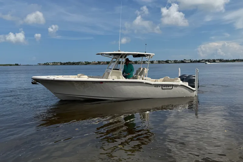 Slide: The Image of 2022 Key West 263 FS boat on calm water under a blue sky. - 18