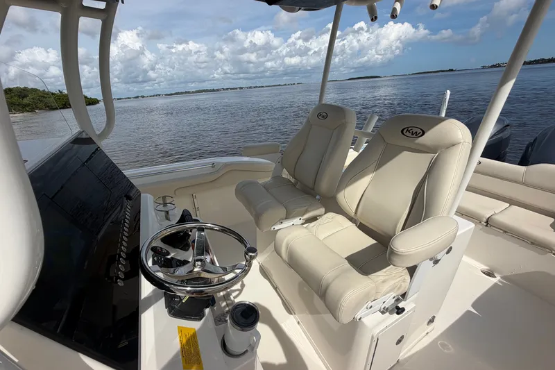 Slide: The Image of 2022 Key West 263 FS boat interior with steering wheel and comfortable seating. - 13
