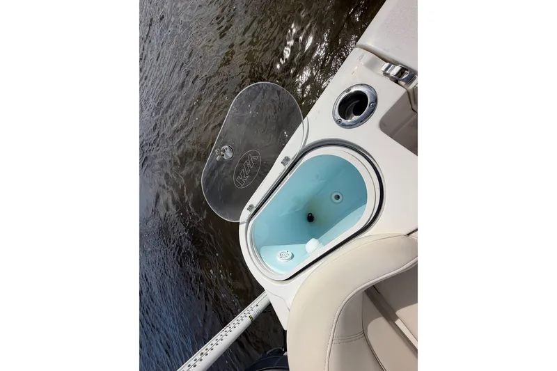 Slide: The Image of Livewell on 2022 Key West 263 FS boat, open lid, near water. - 7