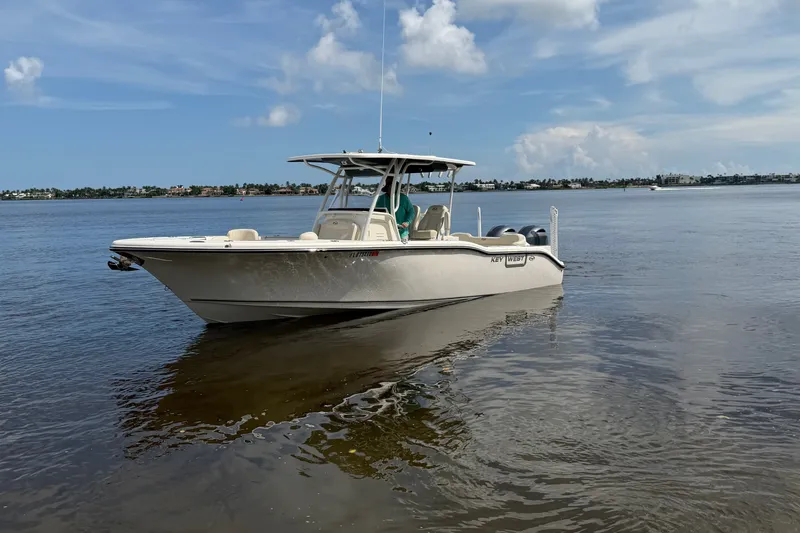 Slide: The Image of 2022 Key West 263 FS boat on calm water under a clear sky. - 17