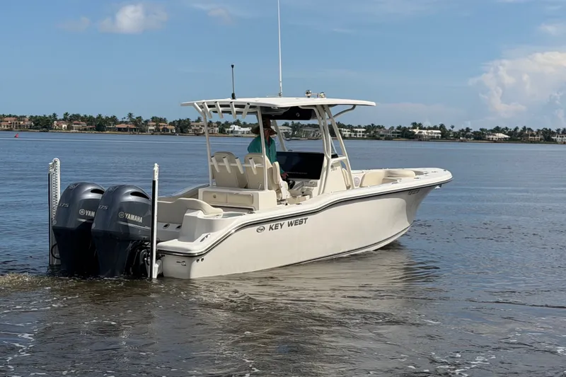Slide: The Image of 2022 Key West 263 FS boat with twin Yamaha engines on calm water. - 22