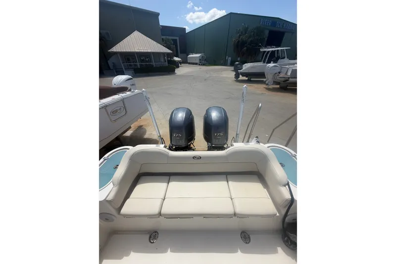 Slide: The Image of 2022 Key West 263 FS boat with twin 175 engines at a marina. - 5