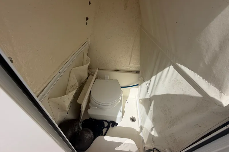 Slide: The Image of Interior of 2022 Key West 263 FS boat with compact marine toilet. - 14