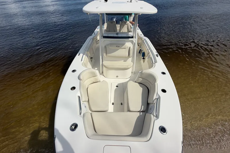 Slide: The Image of 2022 Key West 263 FS boat with spacious seating on calm water. - 16