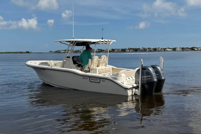 Slide: The Image of 2022 Key West 263 FS boat with dual Yamaha engines on calm water. - 19