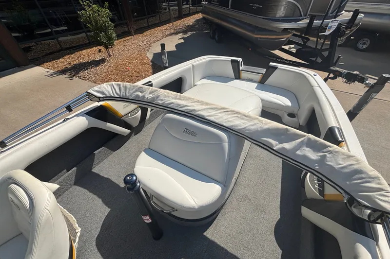 Slide: The Image of Interior view of a 2001 Infinity ZX-1 boat with white seating and carpeted floor. - 12