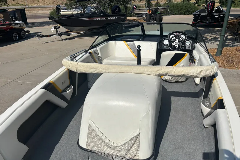 Slide: The Image of Interior of a 2001 Infinity ZX-1 boat with white seating and steering wheel. - 5