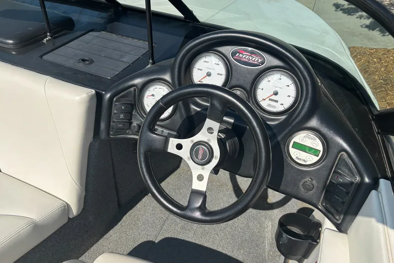 Slide: The Image of Cockpit of 2001 Infinity ZX-1 boat with steering wheel and instrument panel. - 8