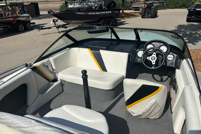 Slide: The Image of Interior of a 2001 Infinity ZX-1 boat with steering wheel and seating. - 6