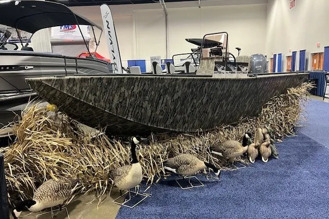 Slide: The Image of 2025 Smoker Craft Pro Sportsman 1872 CC boat displayed with camouflage and duck decoys. - 11