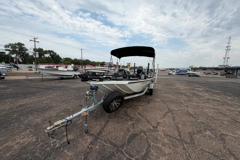 Slide: The Image of 2022 Crestliner XF 189 boat on trailer in parking lot under cloudy sky. - 5