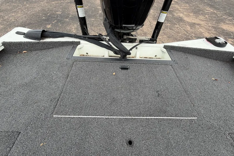 Slide: The Image of 2022 Crestliner XF 189 boat deck with motor and carpeted surface. - 34