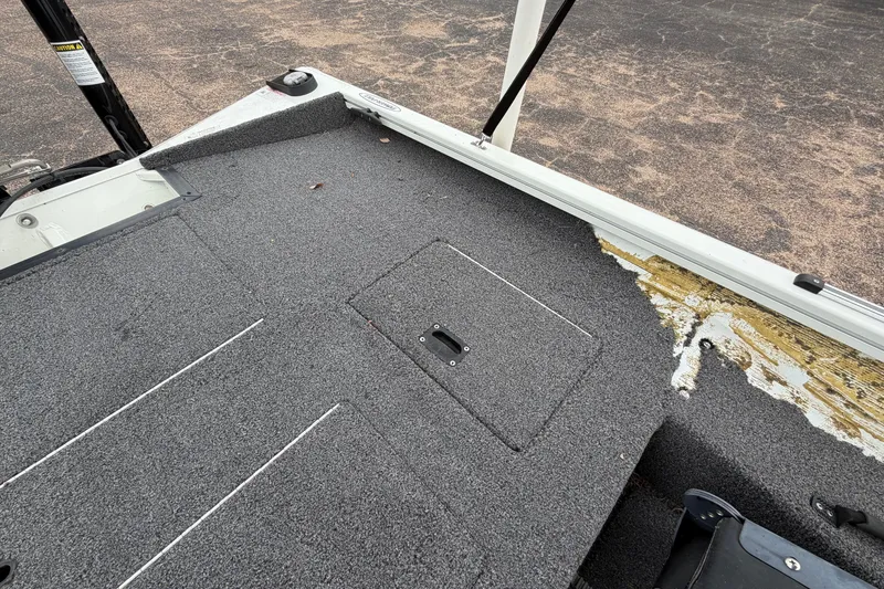 Slide: The Image of 2022 Crestliner XF 189 boat deck with gray carpeting and visible wear. - 32