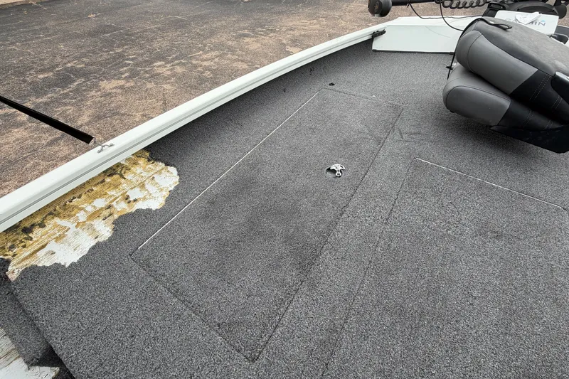 Slide: The Image of 2022 Crestliner XF 189 boat deck with gray carpet and seating. - 14