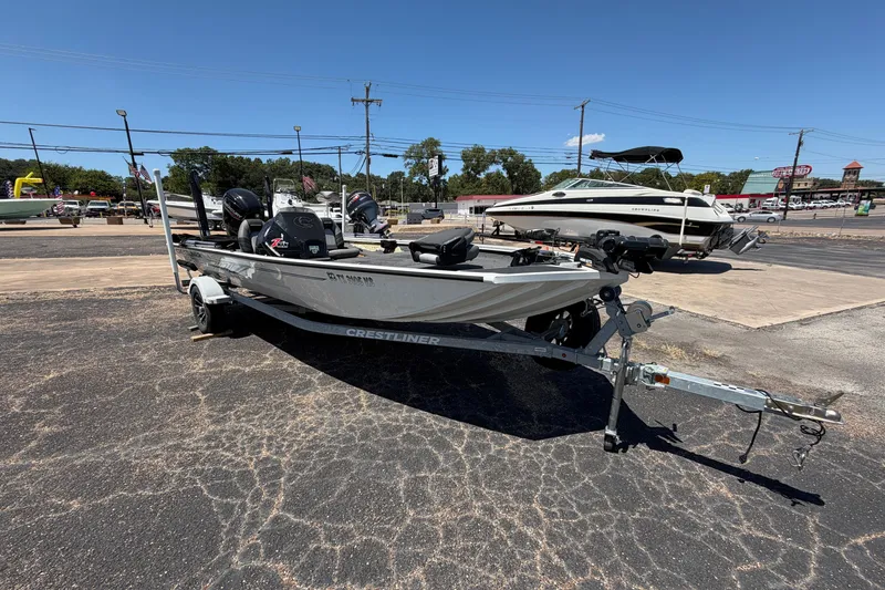 Slide: The Image of 2022 Crestliner XF 189 boat on trailer in outdoor dealership lot. - 1