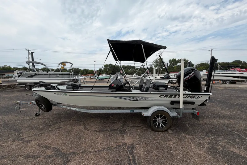 Slide: The Image of 2022 Crestliner XF 189 boat on trailer with canopy, parked outdoors. - 6
