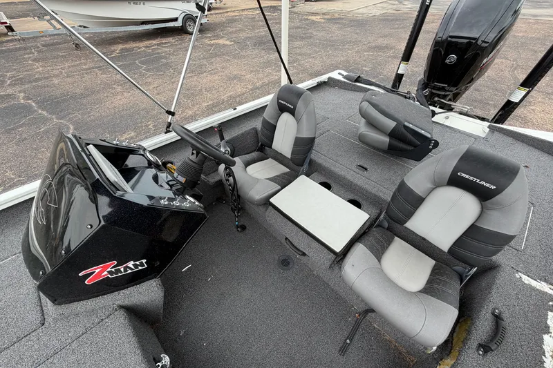 Slide: The Image of 2022 Crestliner XF 189 boat interior with steering console and cushioned seats. - 21