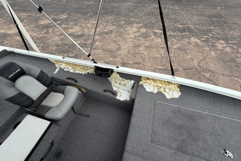 Slide: The Image of 2022 Crestliner XF 189 boat interior with damaged flooring and seating. - 23