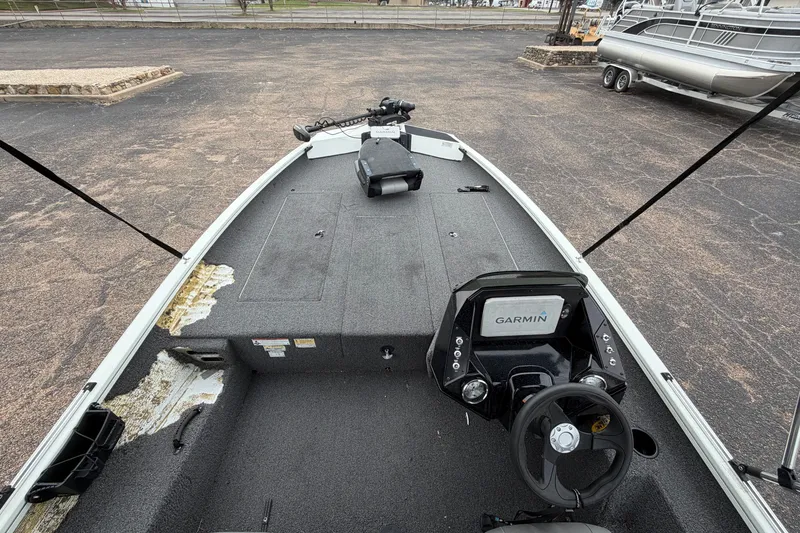 Slide: The Image of 2022 Crestliner XF 189 boat interior with Garmin navigation system, parked on pavement. - 10