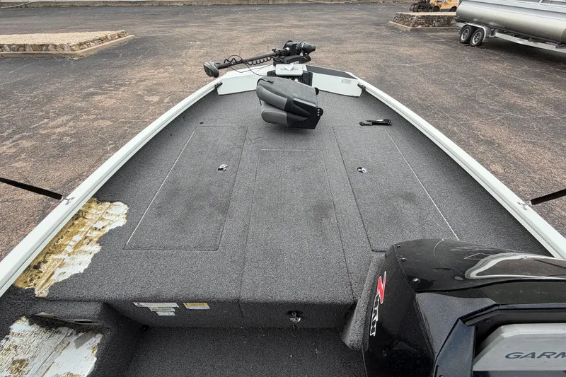 Slide: The Image of 2022 Crestliner XF 189 boat deck with motor and trolling motor, parked on asphalt. - 18