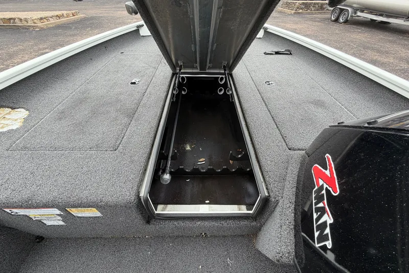 Slide: The Image of 2022 Crestliner XF 189 boat with open storage compartment and Z-Man logo. - 19