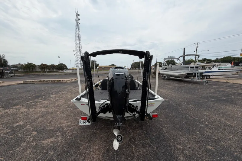 Slide: The Image of 2022 Crestliner XF 189 boat with outboard motor in a parking lot. - 8