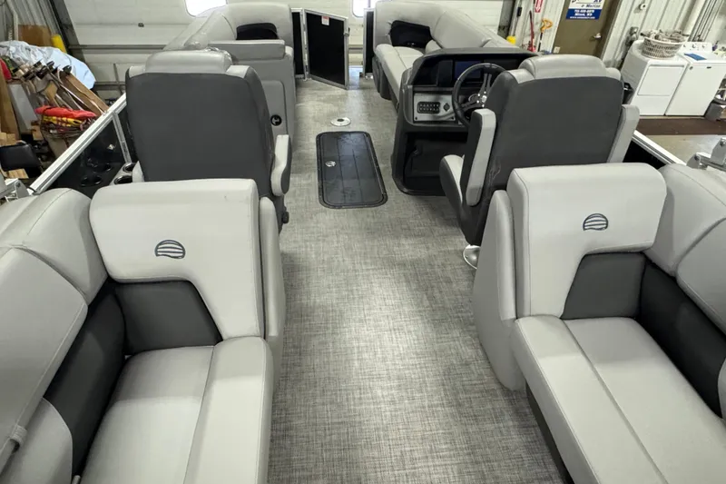 Slide: The Image of Interior of 2026 Sun Tracker Party Barge 22 XP3 with gray seating and steering console. - 15