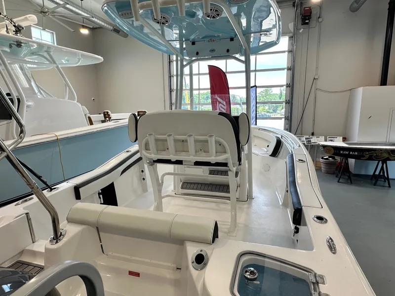 Slide: The Image of The image shows the interior of a 2024 Tidewater 210 CC Adventure boat in a showroom. - 5