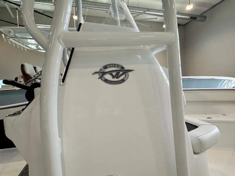 Slide: The Image of Close-up of the helm of a 2024 Tidewater 210 CC Adventure boat indoors. - 2