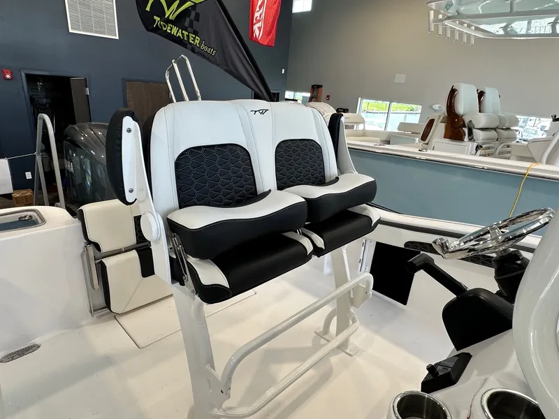 Slide: The Image of The 2024 Tidewater 210 CC Adventure features stylish, cushioned seats and a modern helm console. - 12