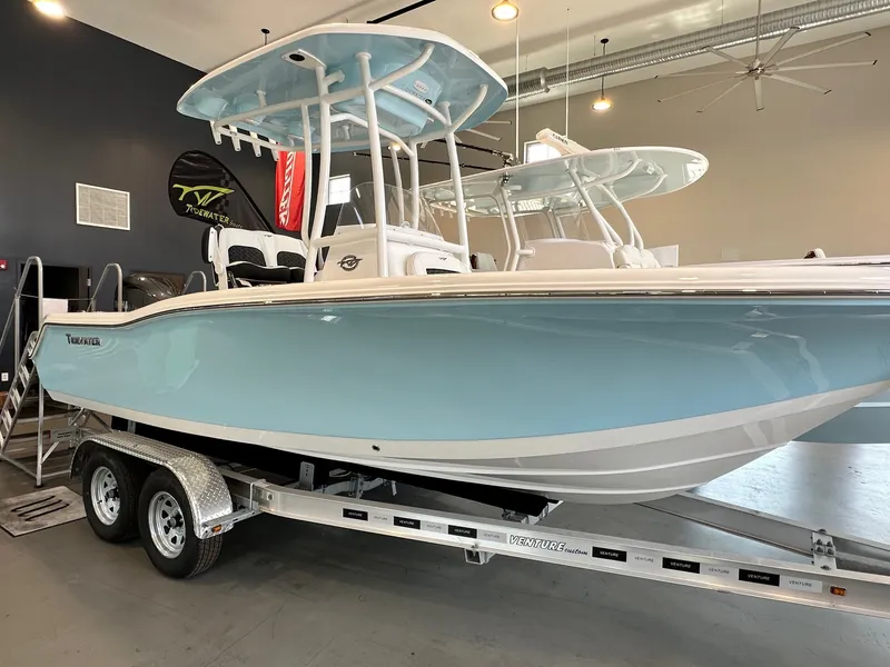 Slide: The Image of 2024 Tidewater 210 CC Adventure in light blue on a trailer in a showroom. - 1