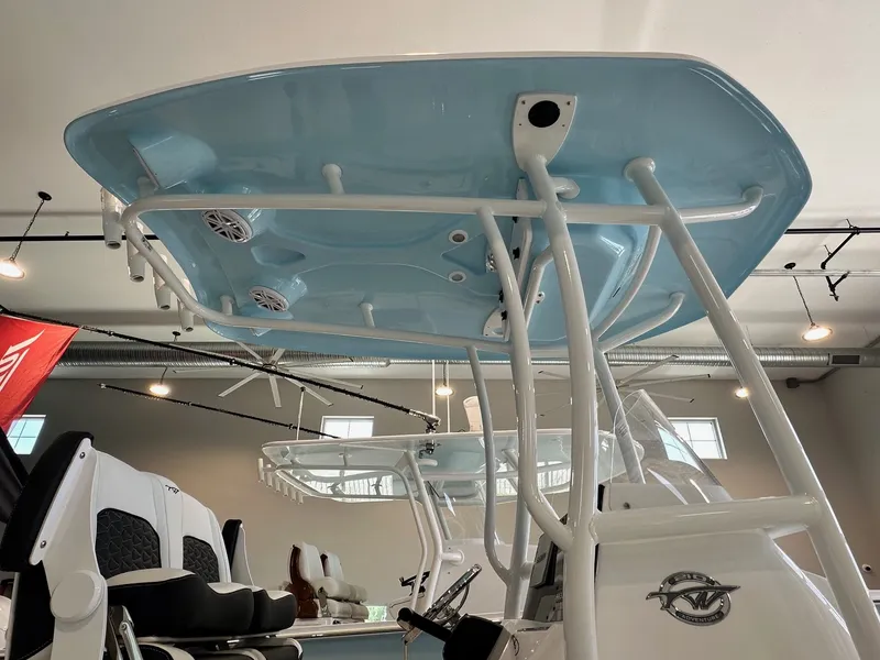 Slide: The Image of The image shows the blue hardtop of a 2024 Tidewater 210 CC Adventure boat in a showroom. - 3