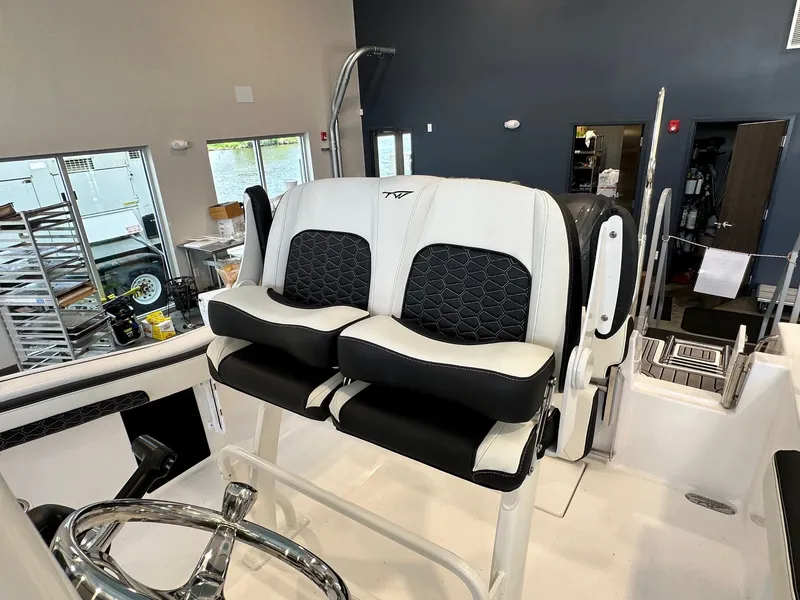Slide: The Image of The 2024 Tidewater 210 CC Adventure features stylish, cushioned seats with a modern steering wheel. - 8