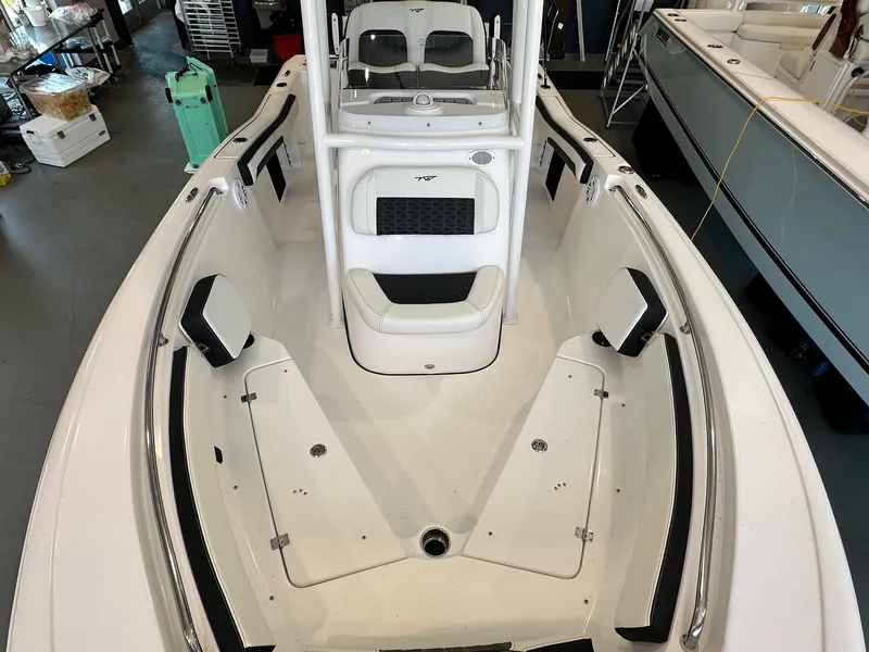 Slide: The Image of The image shows the deck of a 2024 Tidewater 210 CC Adventure boat with seating and storage. - 10