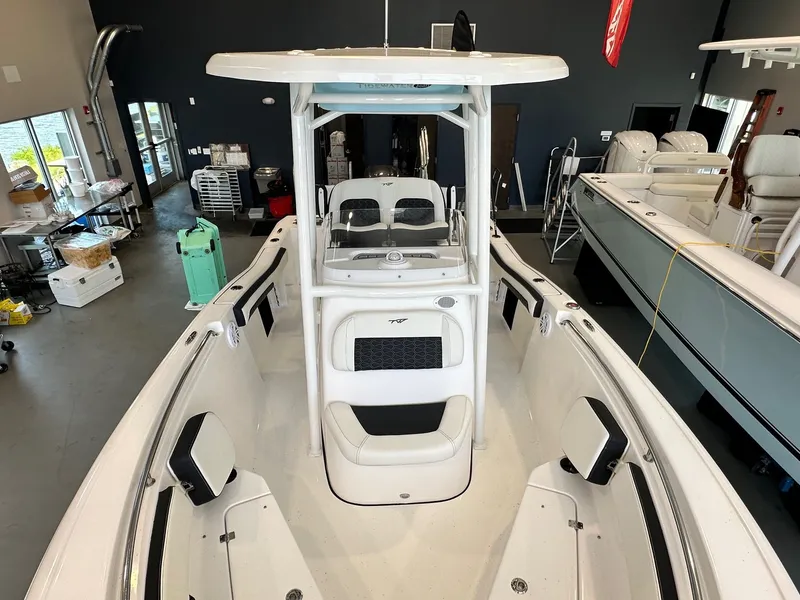 Slide: The Image of The image shows a 2024 Tidewater 210 CC Adventure boat in a showroom. - 11