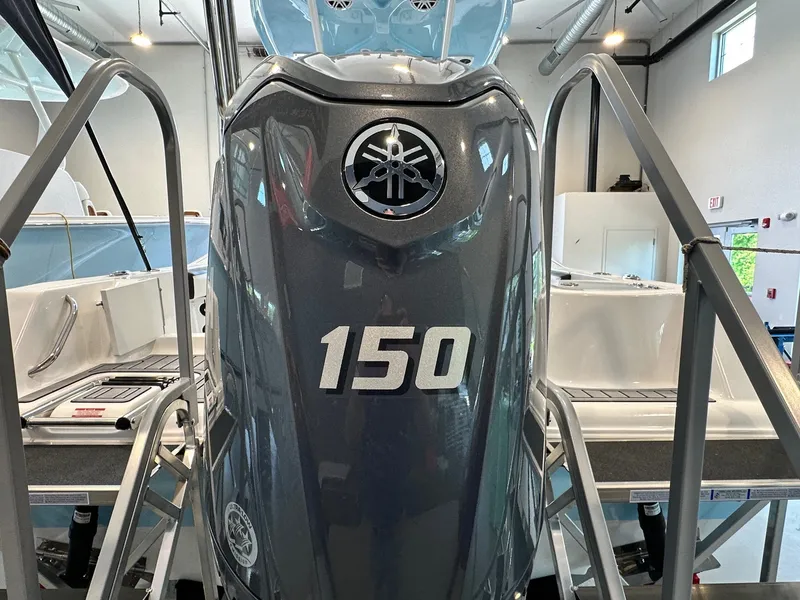 Slide: The Image of A gray outboard motor labeled "150" is mounted on a boat. - 4