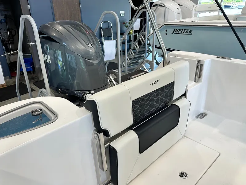 Slide: The Image of The image shows the stern of a Tidewater 210 CC Adventure boat with a Yamaha outboard motor. - 14