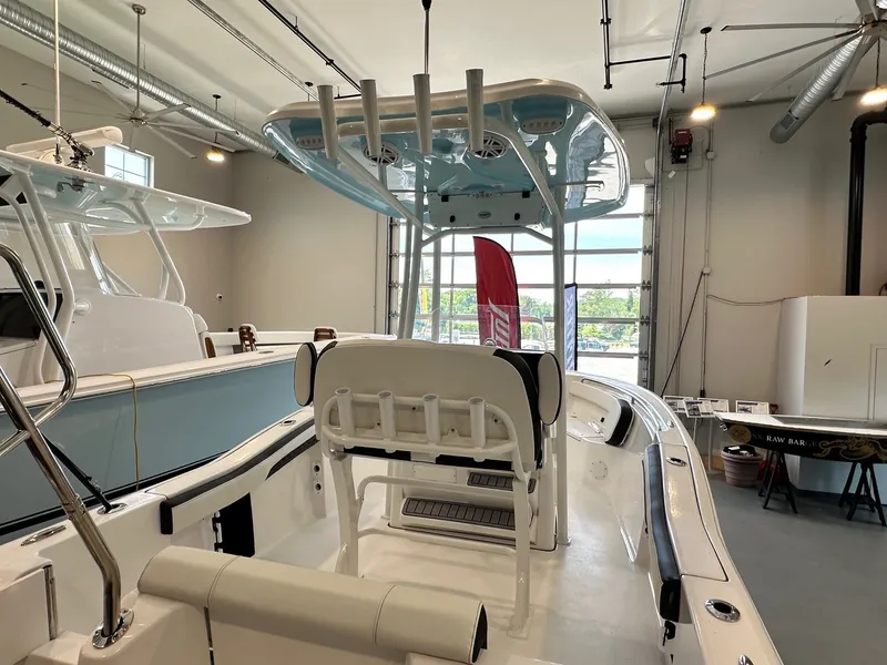 Slide: The Image of The image shows a 2024 Tidewater 210 CC Adventure boat in a showroom. - 6