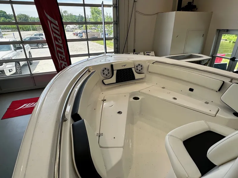 Slide: The Image of The image shows the bow area of a 2024 Tidewater 210 CC Adventure boat in a showroom. - 9
