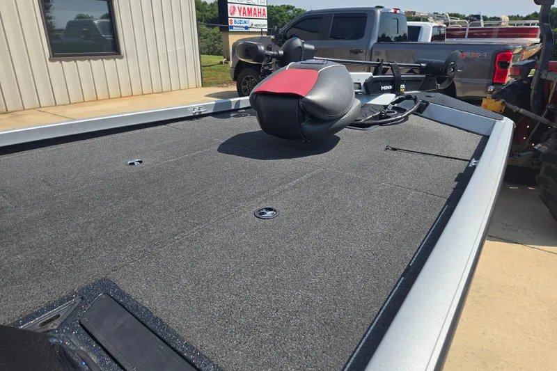 Slide: The Image of 2018 Ranger RT188 boat deck with seat, parked near Yamaha dealership. - 18