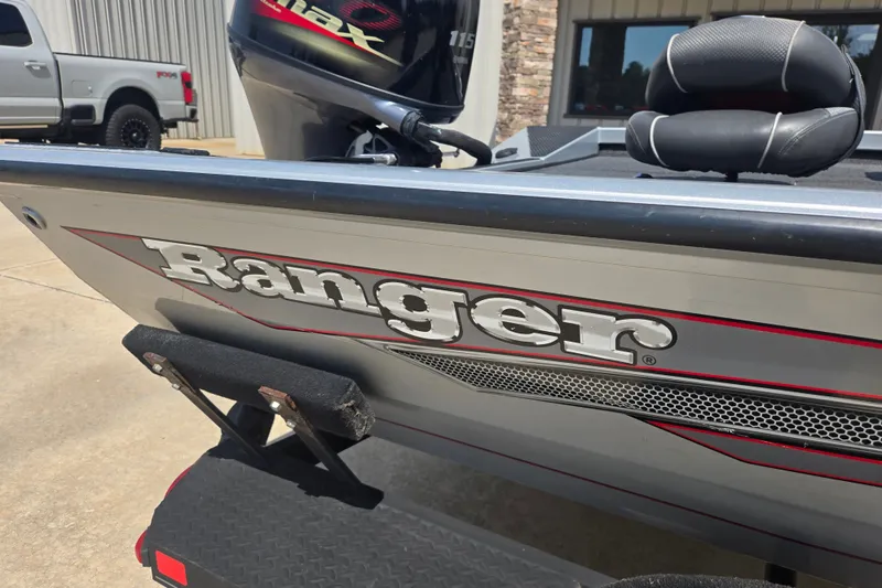 Slide: The Image of 2018 Ranger RT188 boat with Yamaha outboard motor, parked near a truck. - 22