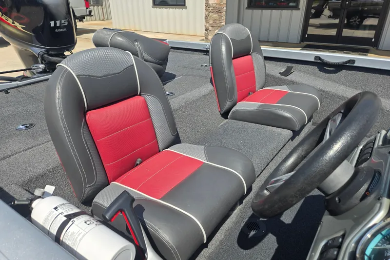 Slide: The Image of 2018 Ranger RT188 boat interior with red and gray seats, steering wheel, and Yamaha motor. - 19