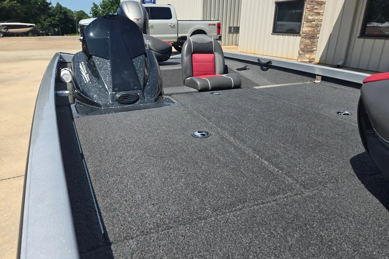 Slide: The Image of 2018 Ranger RT188 boat with carpeted deck and seating, parked outdoors. - 15