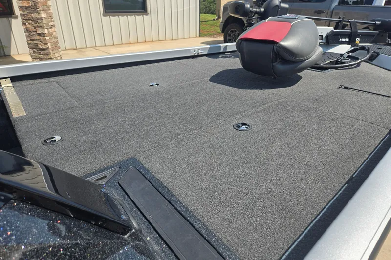 Slide: The Image of 2018 Ranger RT188 boat deck with carpeted surface and seat, parked outdoors. - 17
