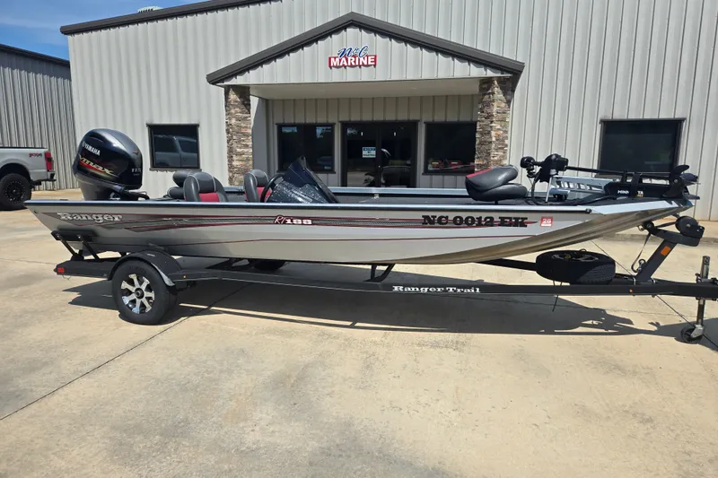 The Image of 2018 Ranger RT188 boat on trailer outside marine dealership. - 1