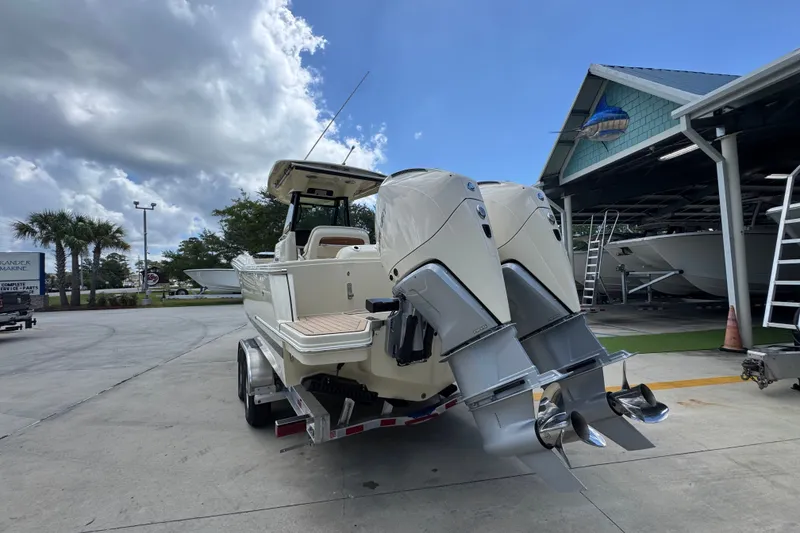 Slide: The Image of 2027 Chris-Craft Catalina 28 boat with dual outboard engines at a marina. - 17