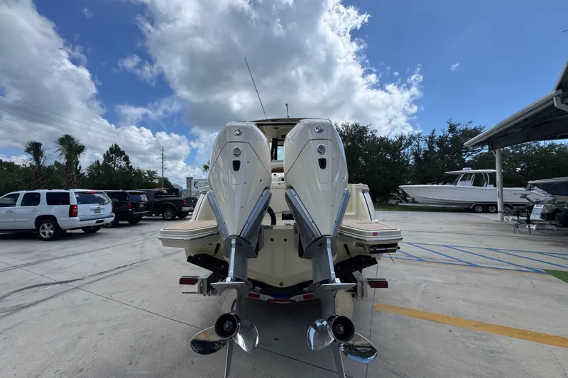 Slide: The Image of 2027 Chris-Craft Catalina 28 with dual outboard motors in a marina setting. - 16