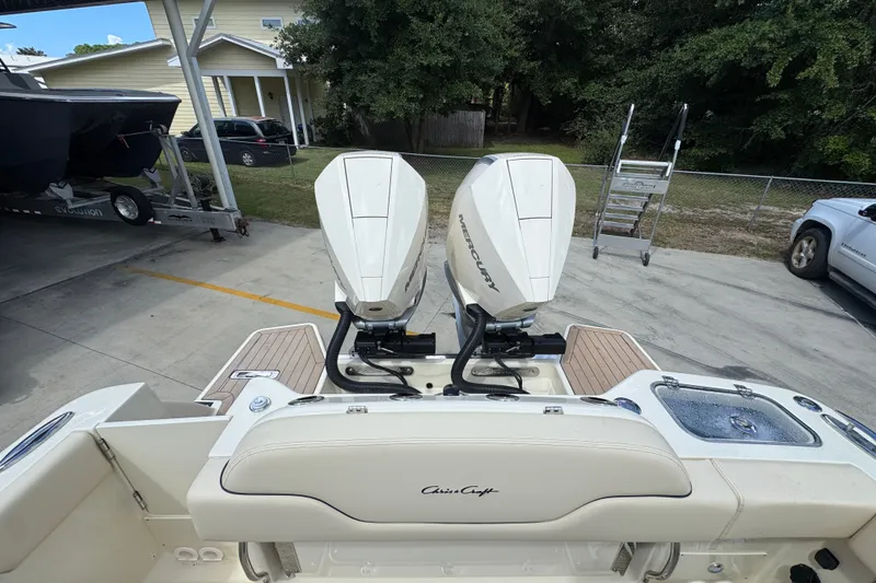 Slide: The Image of 2027 Chris-Craft Catalina 28 boat with dual Mercury engines, parked outdoors. - 43