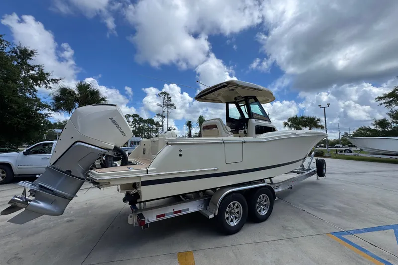 Slide: The Image of 2027 Chris-Craft Catalina 28 boat on trailer, parked outdoors under cloudy sky. - 13