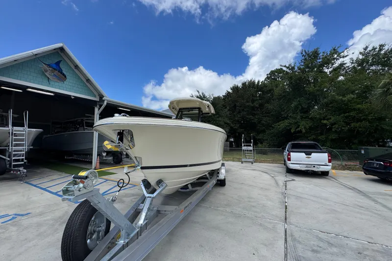 Slide: The Image of 2027 Chris-Craft Catalina 28 boat on trailer, parked outdoors near a building. - 5